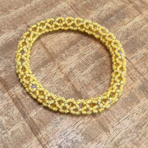 Roll over armband geel/goud